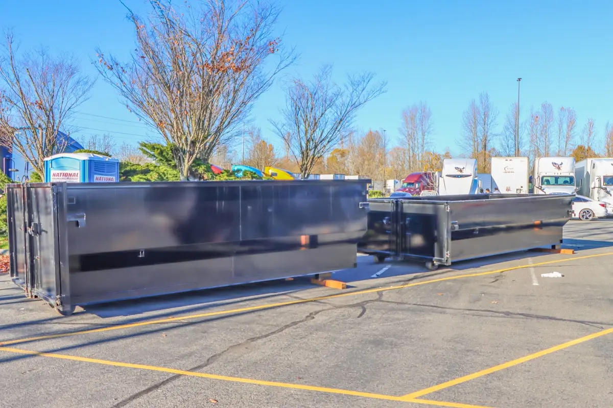 Professional dumpster rental service with roll-off container on residential driveway in Upper Nazareth